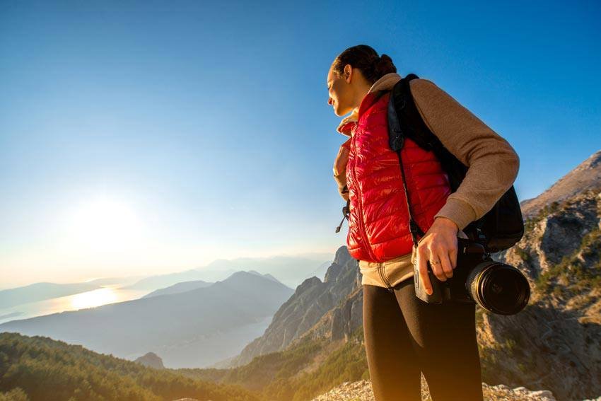 Female traveler taking photos at Banff National Park, solo trip in Canada
