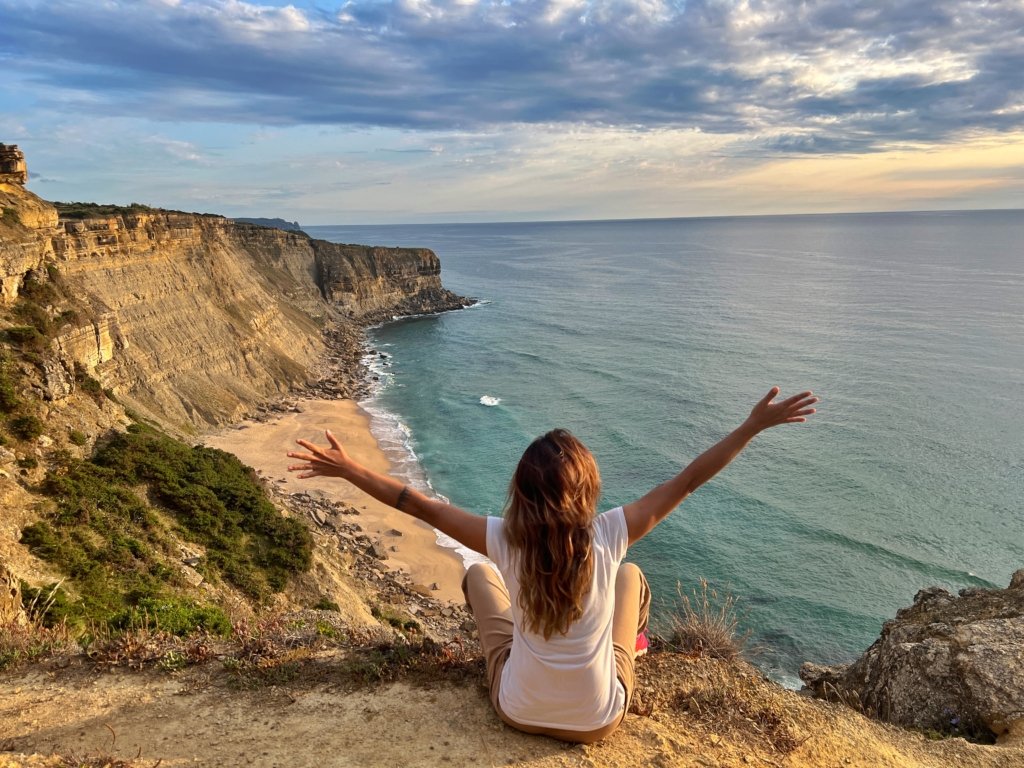 Woman enjoying sunset in Lisbon, safe solo female travel in Portugal