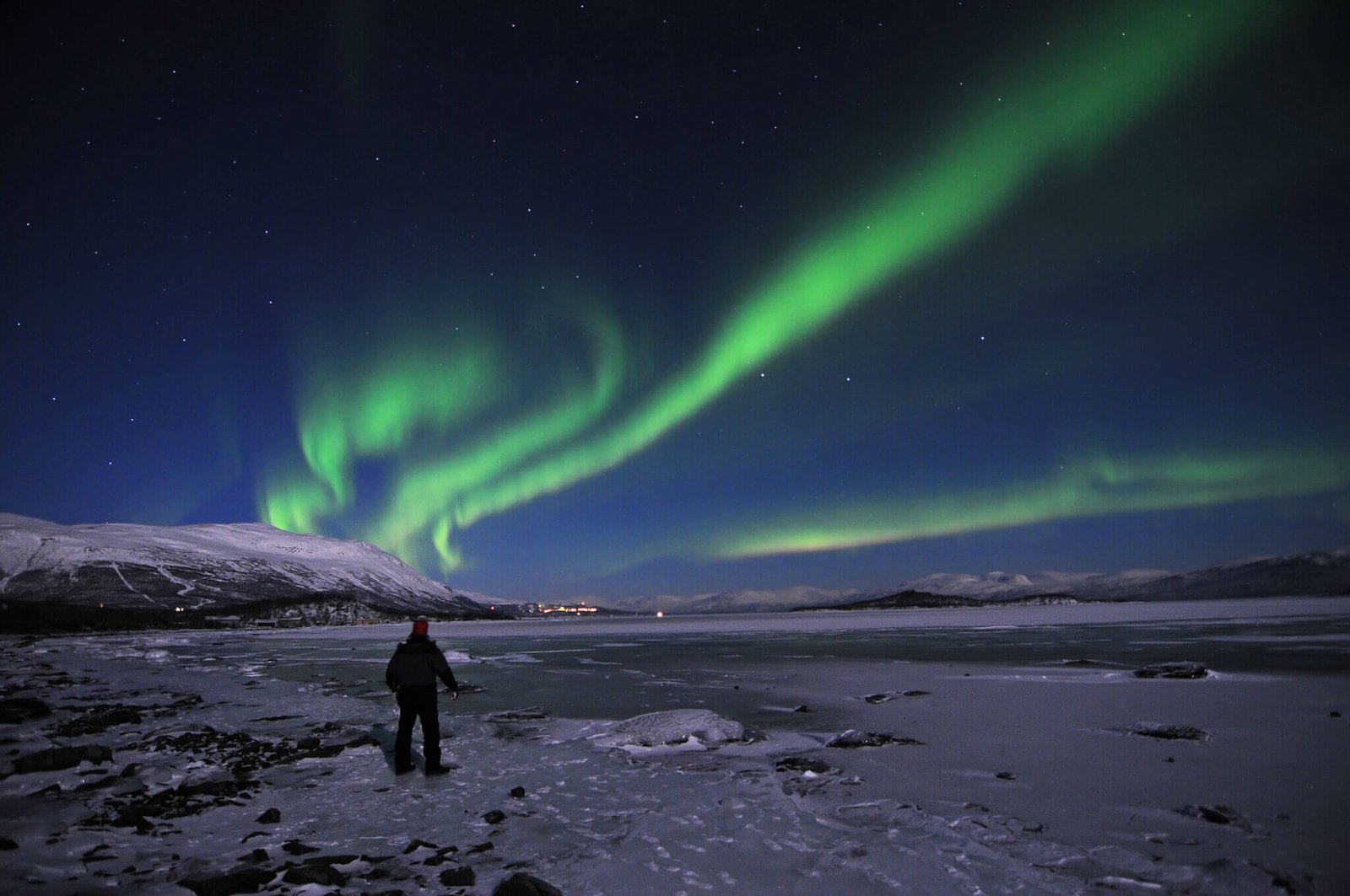 Spectacular Northern Lights display over snowy landscapes in Abisko, Sweden