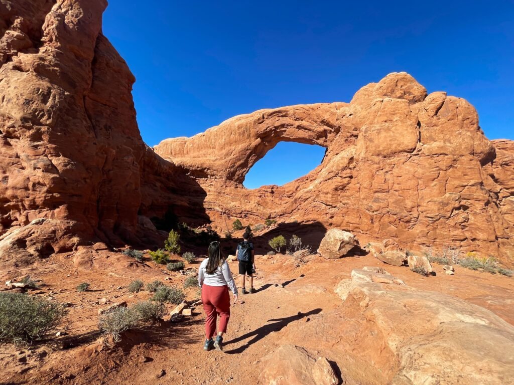 Father-son duo exploring Devil’s Garden rock arches in Arches National Park, Utah