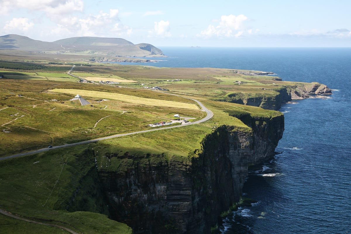 Ireland: The Emerald Isle Inspiring Wanderlust" – Rolling green hills and ancient ruins in Ireland’s countryside.