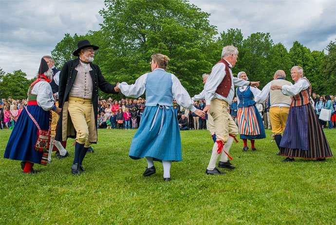 Celebrating Sweden’s Midsummer Festival with maypoles, flower crowns, and traditional dances