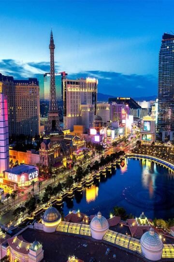 Colorful night view of the Las Vegas Strip with hotels and fountains, often seen before starting Las Vegas day trips