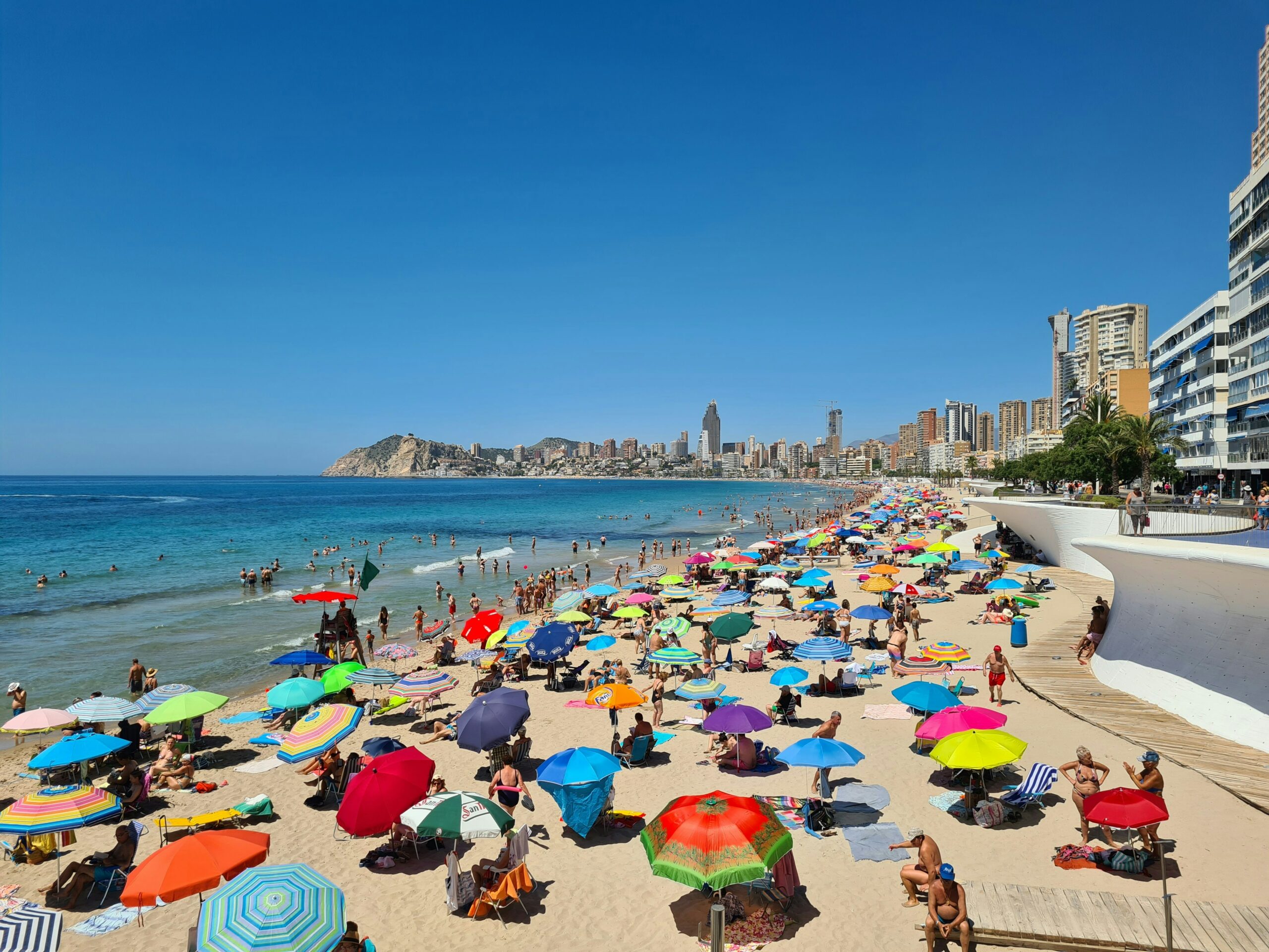 Family walking along Barcelona Beach, a scenic good family trip destination.