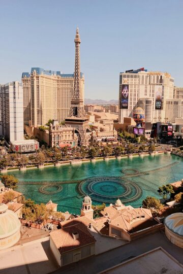 Vegas smoking hotels view featuring the Paris Las Vegas Eiffel Tower and Bellagio fountains during the day